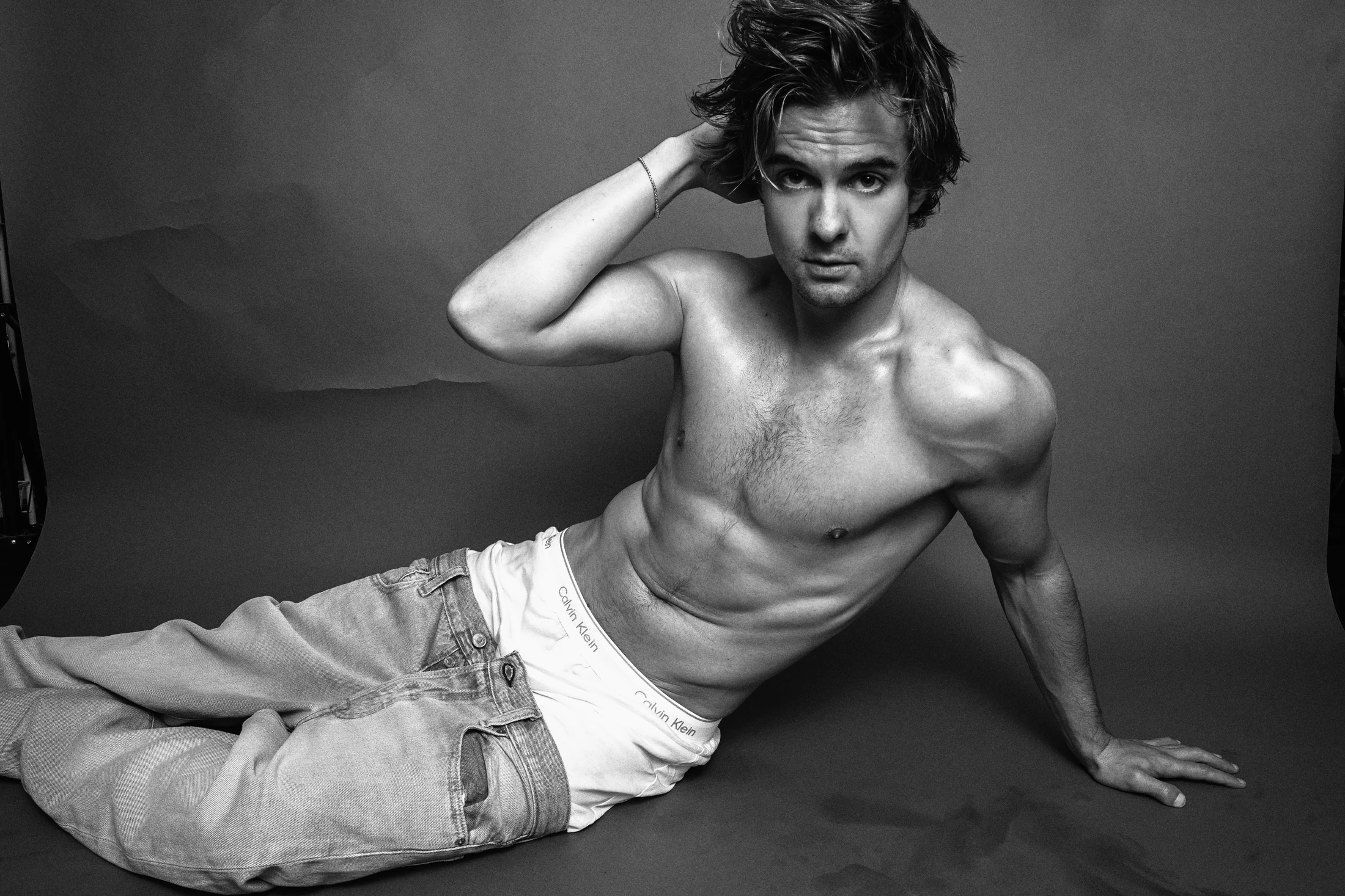 Jake Crossman reclining in a black-and-white editorial photograph