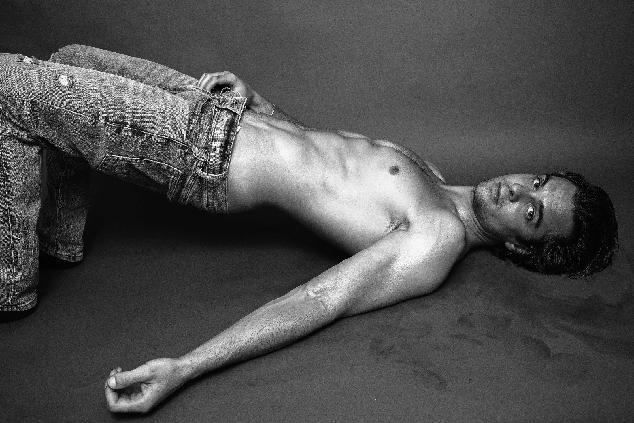 Jake Crossman lying back in a black-and-white editorial photograph