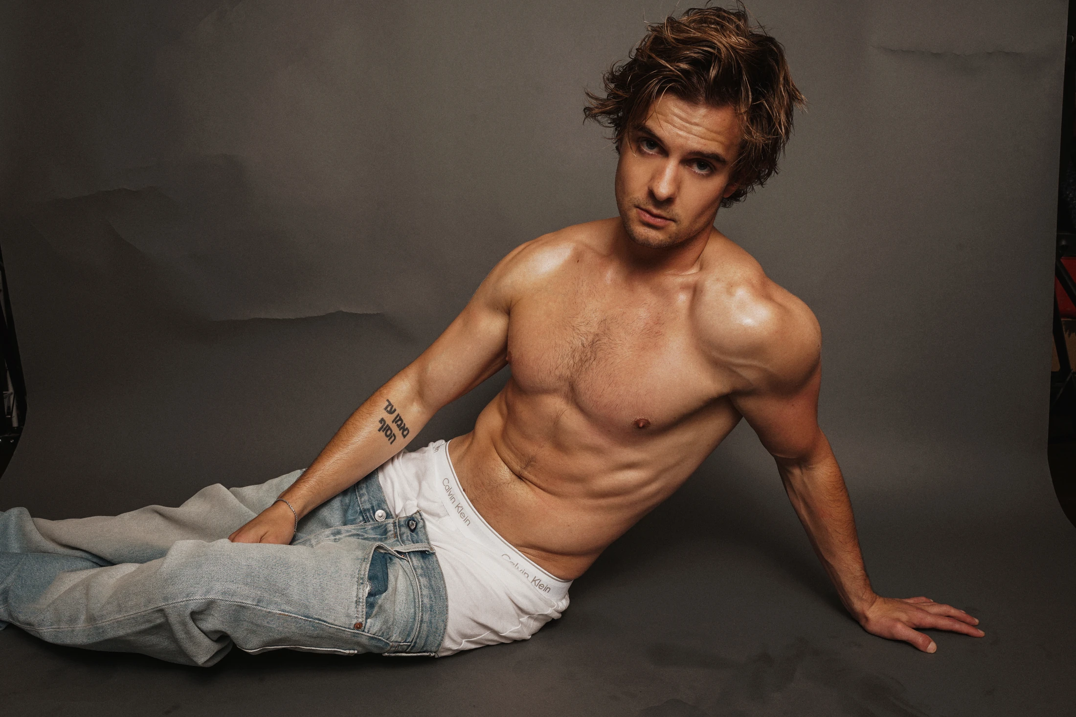 Jake Crossman reclining in a wide black-and-white editorial photograph