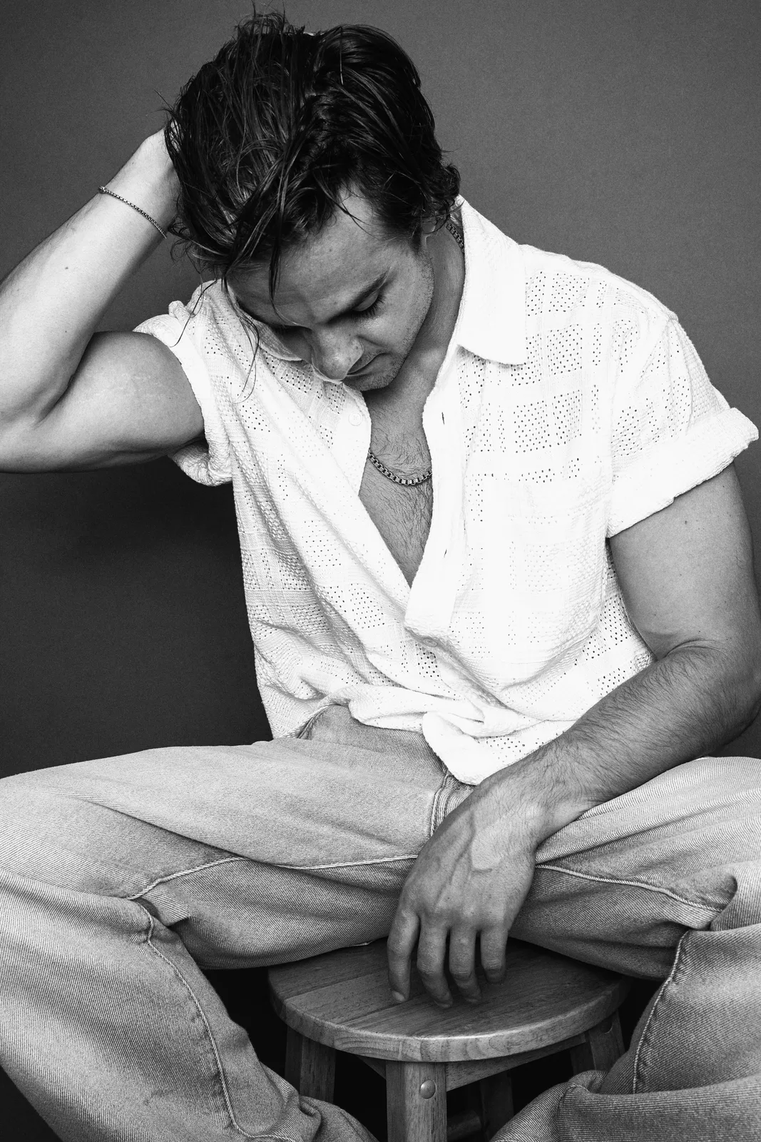 Jake Crossman seated in a contemplative black-and-white portrait